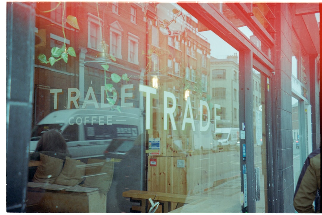reflection-of-a-street-scene-in-a-coffee-shop-window-nbrcuot8nrk